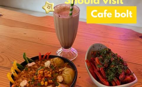 A shake and loaded bowls on a wooden table