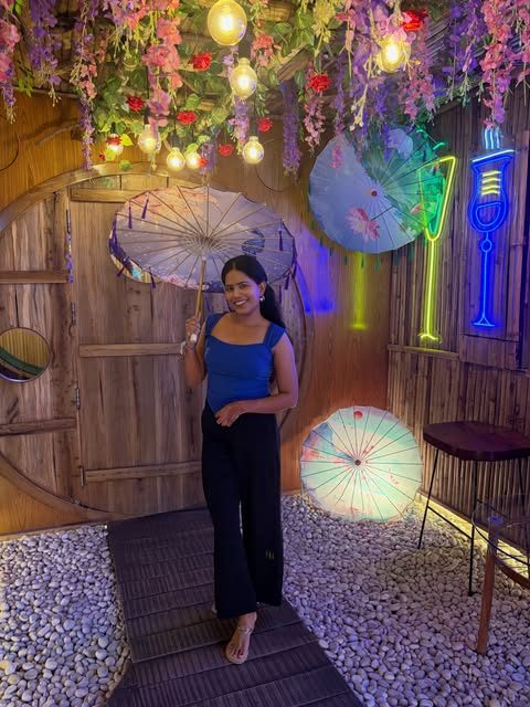 Guest under the wisteria tree with paper umbrellas and neon